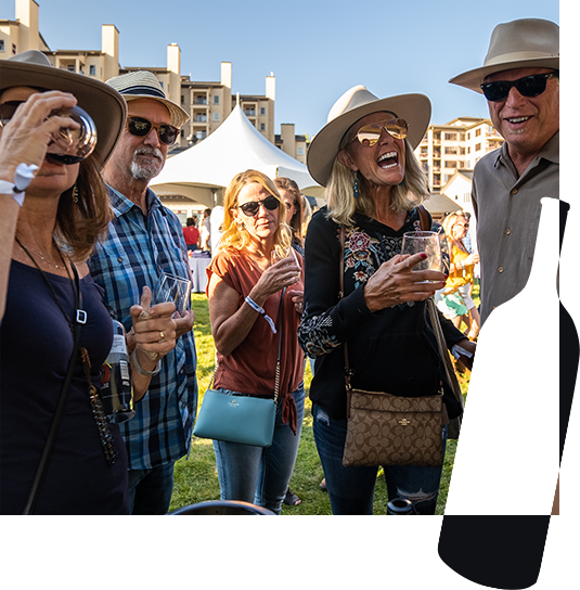 Group of happy people wearing hats and sunglasses drinking wine